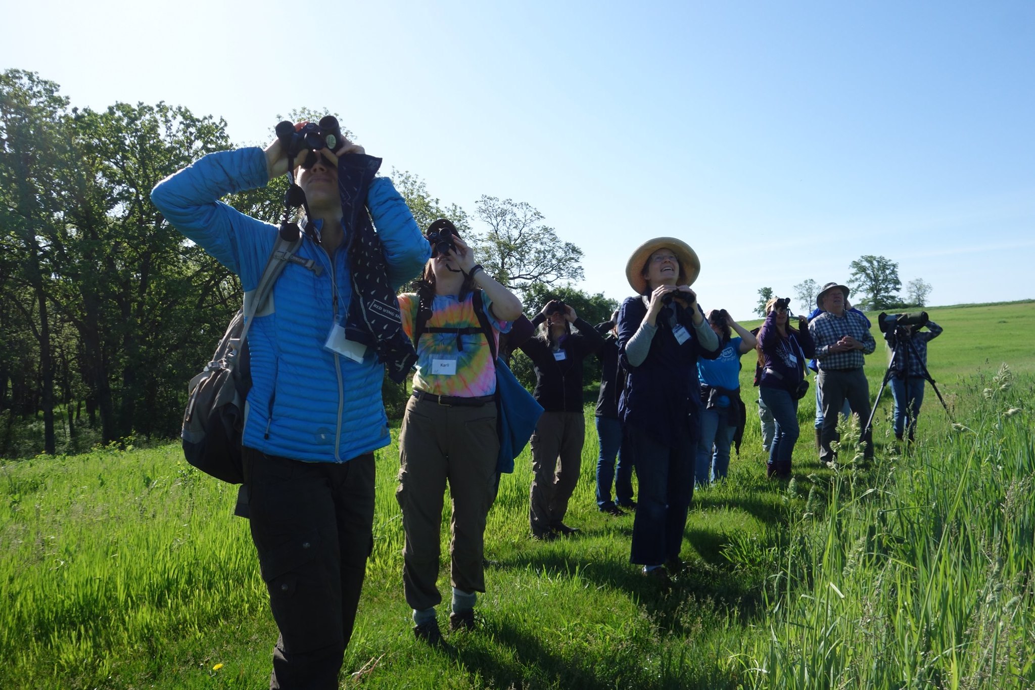 Master Naturalists participate in a bird hike with binoculars and spotting scopes